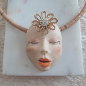 face pendant on cork cord by french ostrich