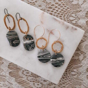 gray and gold earrings by french ostrich