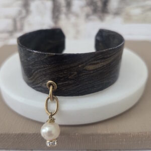 black and gold cuff bracelet with teal dangle by french ostrich